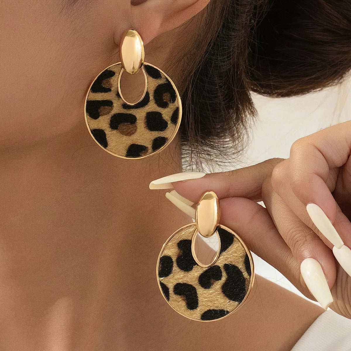 Leopard circle dangle earrings by Plush Fashion Hub featuring gold-tone hoops with leopard print design and dangling charm.