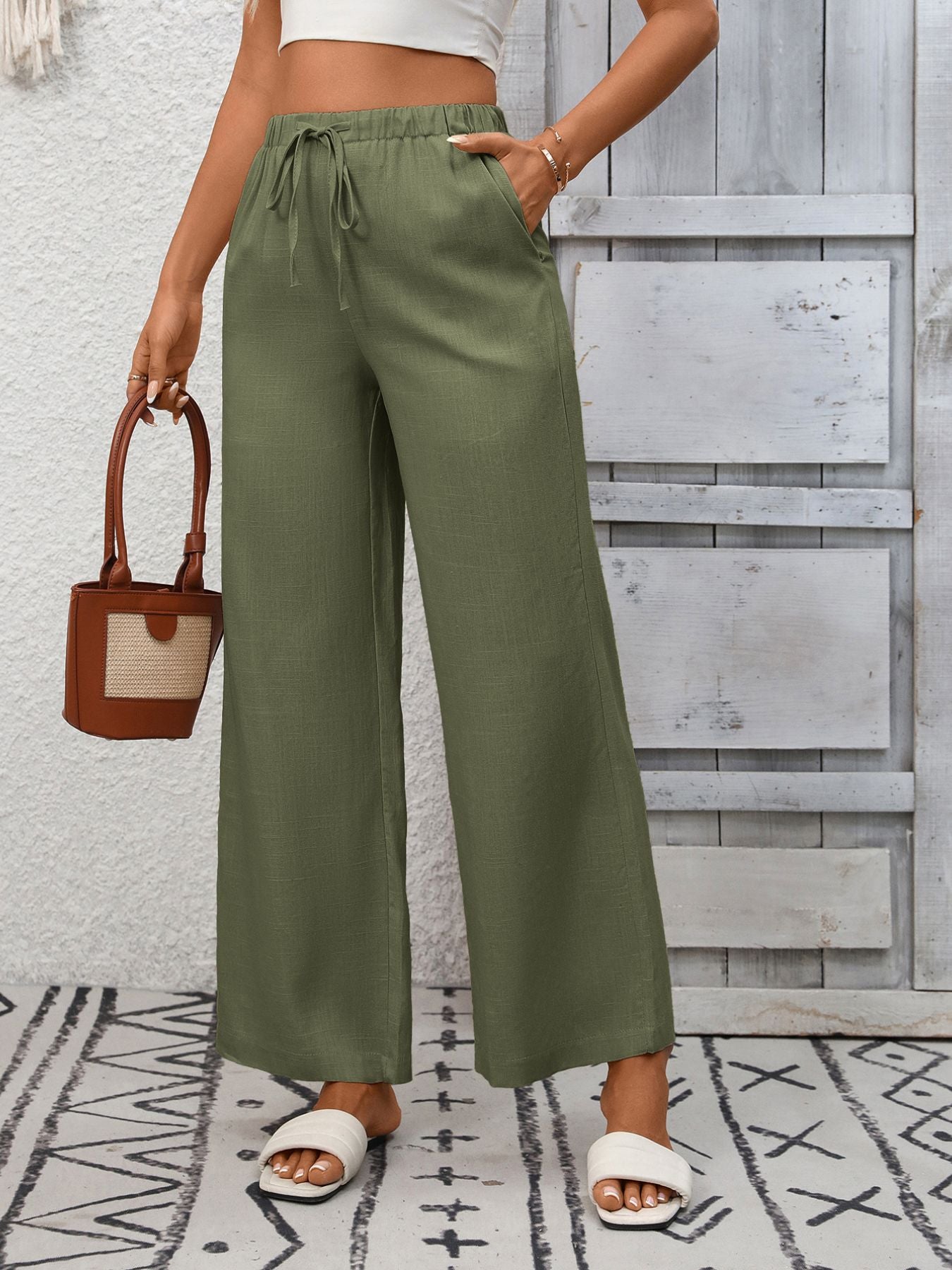 Women's high-waisted wide-leg drawstring pants in soft breathable viscose, shown in a relaxed fit with a comfortable waistband.