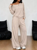 Plus size loose fit one-shoulder t-shirt and matching pants set from Trendsi, featuring a relaxed, comfortable style.