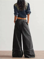 Shopimist floral appliques wide leg jeans showing embroidered floral details on light denim with a relaxed fit.