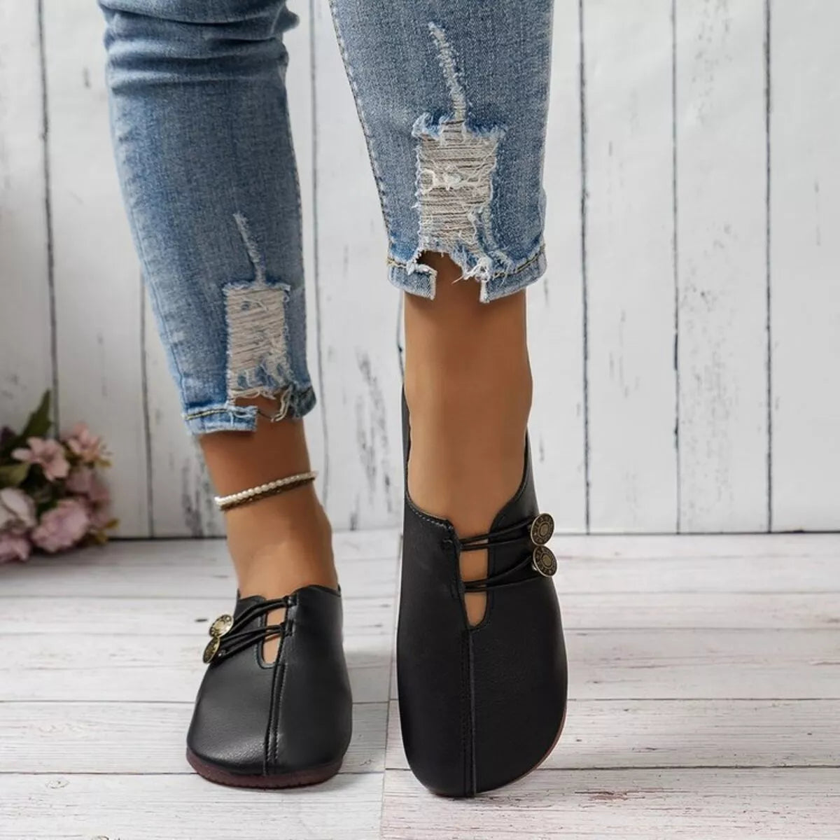 Women's casual slip-on shoes with button details by Trendsi, featuring a comfortable, stylish design for everyday wear.