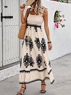 Plush Fashion Hub smocked printed wide strap maxi dress featuring a flowy silhouette and vibrant floral patterns.