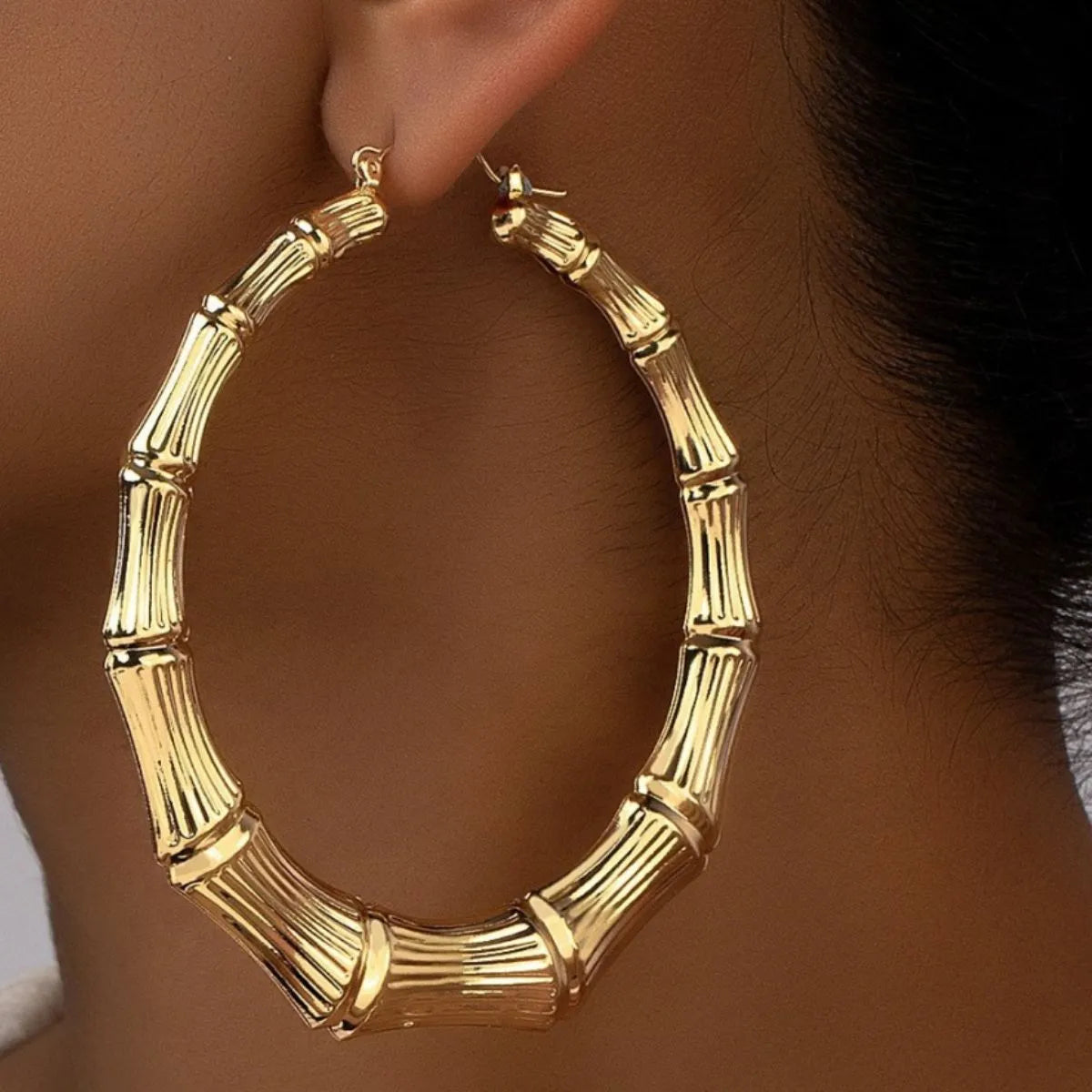 Stainless steel textured hoop earrings with a polished finish, stylish jewelry accessory for women.