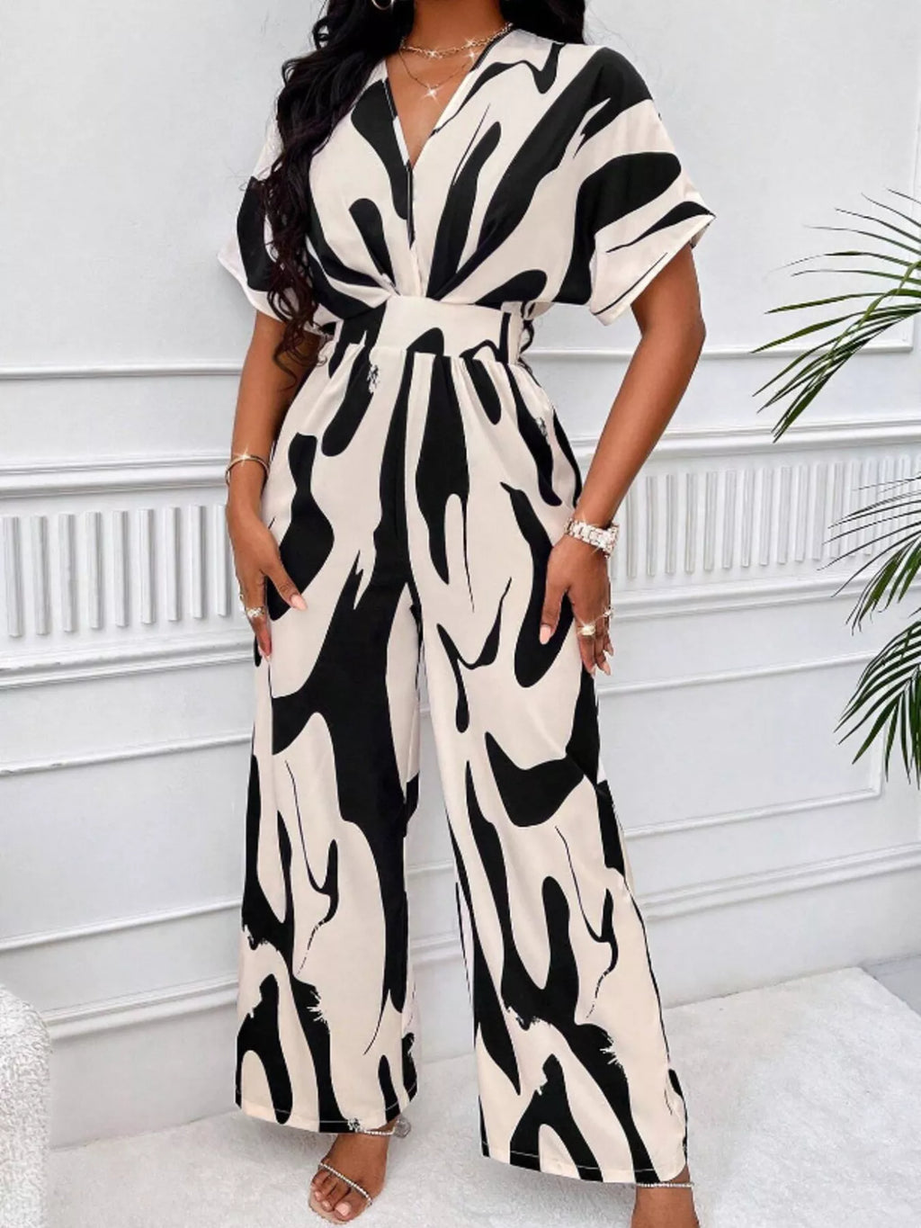 Abstract print wide-leg jumpsuit from Trendsi, featuring a stylish design with flowing wide-leg silhouette and vibrant pattern.