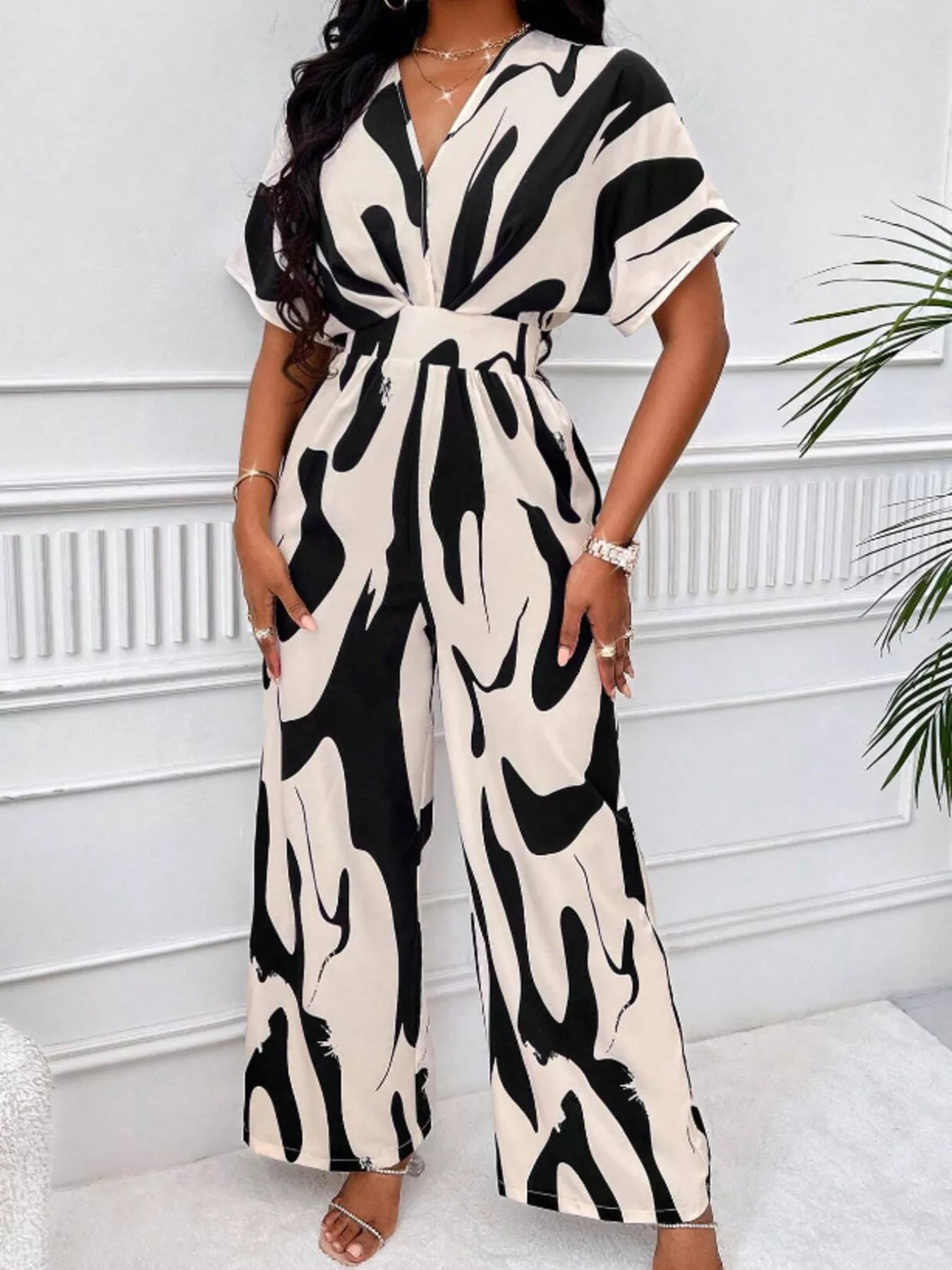 Abstract print wide-leg jumpsuit from Trendsi, featuring a stylish design with flowing wide-leg silhouette and vibrant pattern.