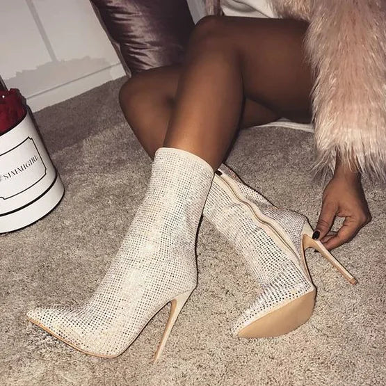 Elegant women’s rhinestone high heel boots with pointed toes, featuring sparkling embellishments and a sleek silhouette.