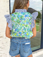 Floral patchwork cotton blouse with flutter sleeves and V-neck, casual dress by Trendsi, shown in vibrant fabric detail.