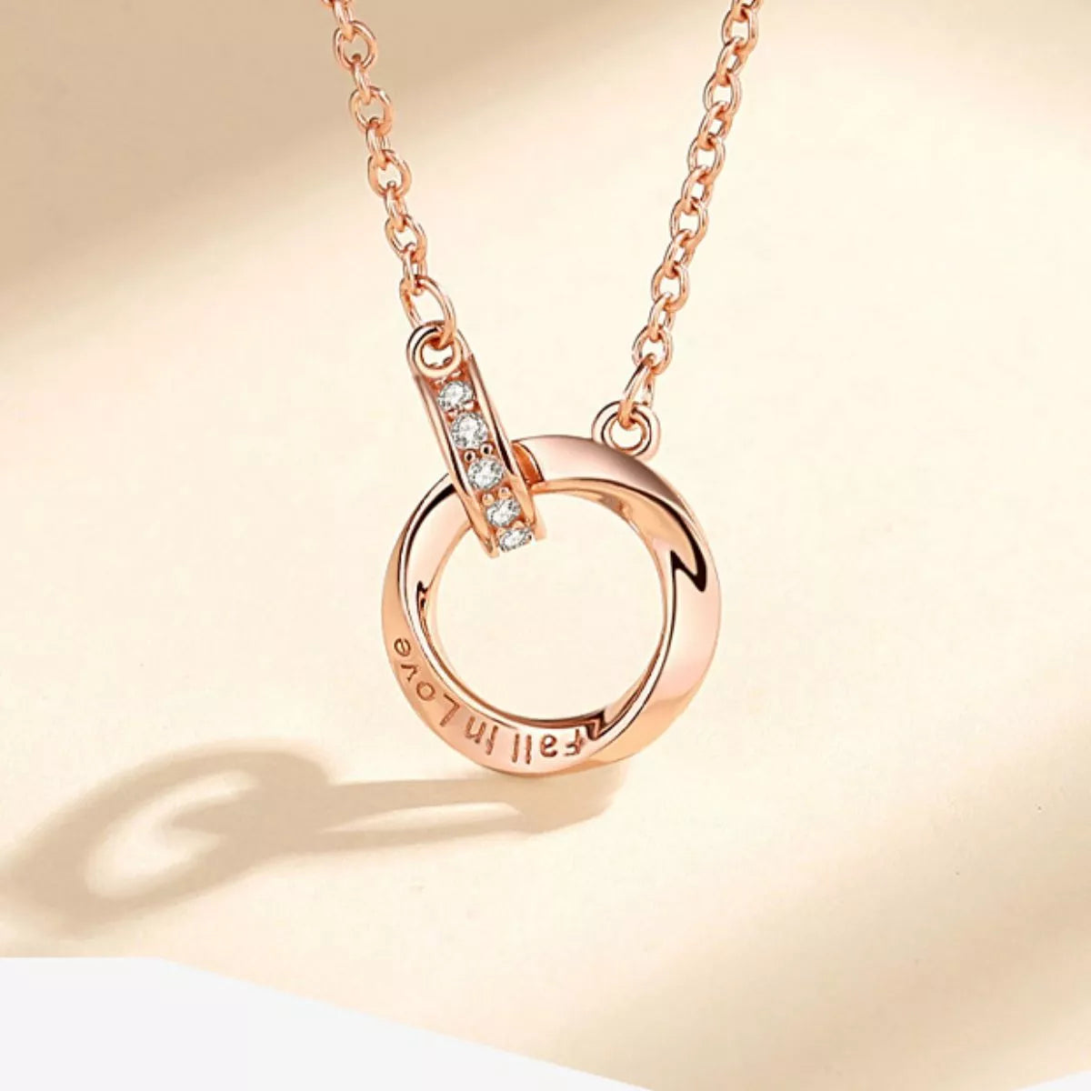 Sterling silver necklace with 18K rose gold plating, featuring a delicate chain and elegant pendant, from Plush Fashion Hub.