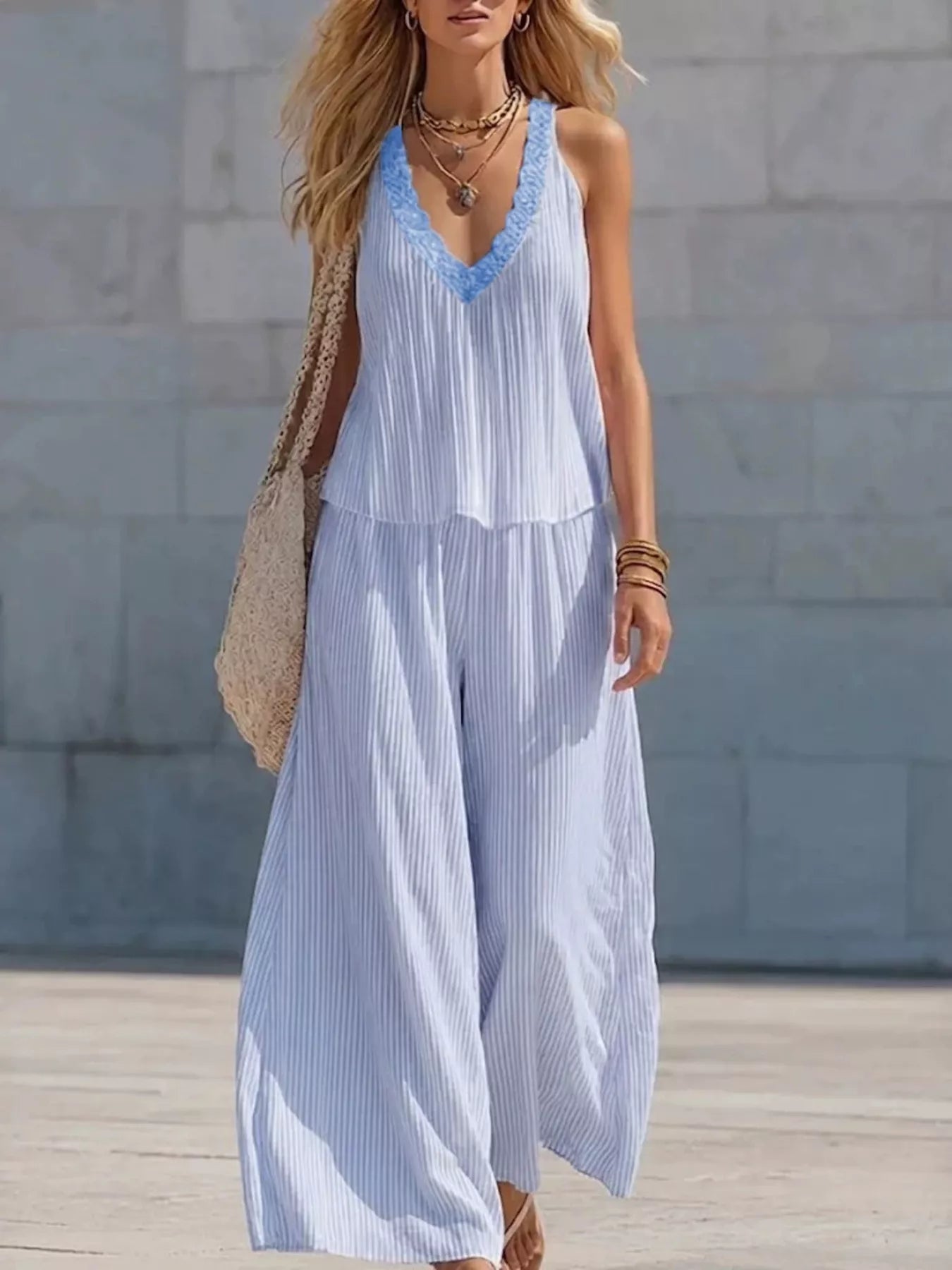 Striped V-neck tank top and wide-leg pants set by Plush Fashion Hub, featuring a stylish two-piece outfit with bold stripe patterns.