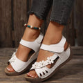 Floral embellished wedge sandals by Shopimist with colorful flower decorations and tan wedge heel, perfect for summer wear.