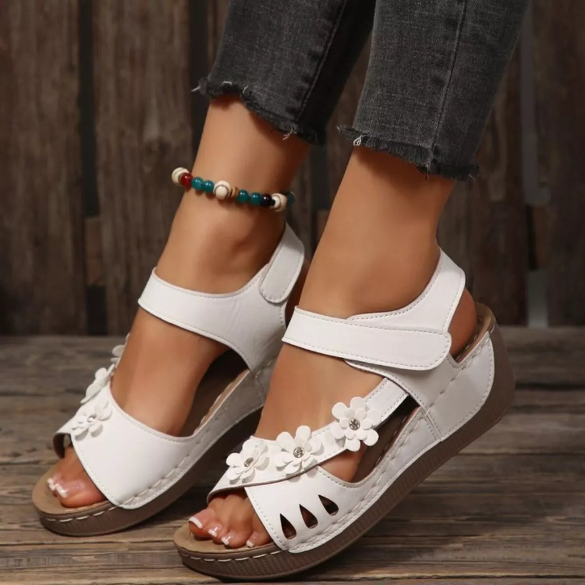 Floral embellished plush fashion hub wedge sandals with decorative flower details and comfortable strap design.