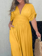 Plus size maxi dress with slit V-neck, smocked waist, and flowing fabric, by Trendsi, perfect for casual or dressy occasions.