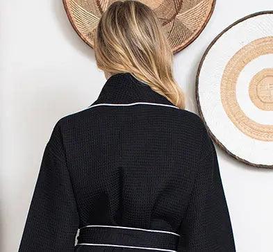 Back view of women's black waffle piping bathrobe by Plush Fashion Hub, lightweight spa-style robe with small piping details.