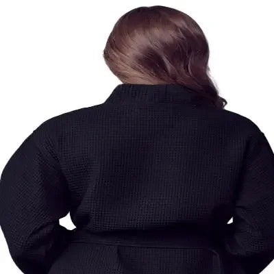 Back view of black knee-length waffle robe for women by Plush Fashion Hub, showcasing the cozy textured fabric and relaxed fit.