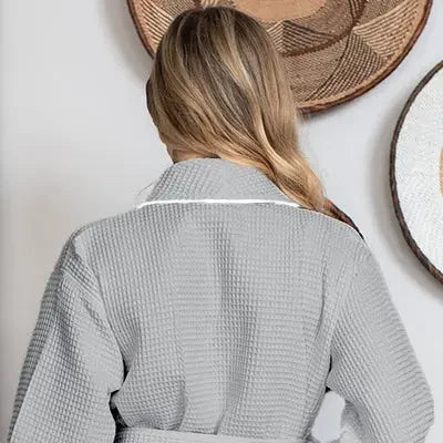 Back view of small gray knee-length waffle robe for women by Plush Fashion Hub, featuring piping and comfortable fabric.