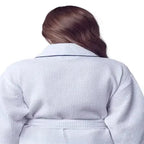 Back view of Plush Fashion Hub women's knee-length waffle robe in white with piping, showcasing its cozy design and soft fabric.
