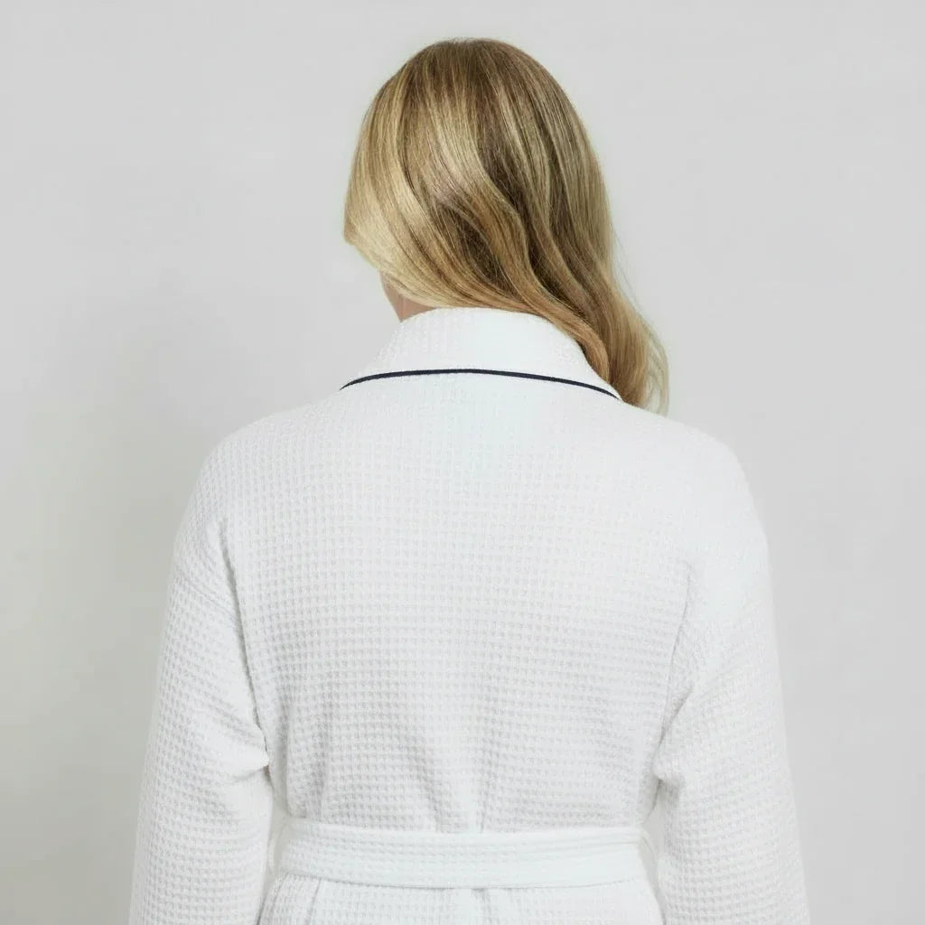 Back view of a small white knee-length waffle robe for women with piping from Plush Fashion Hub.