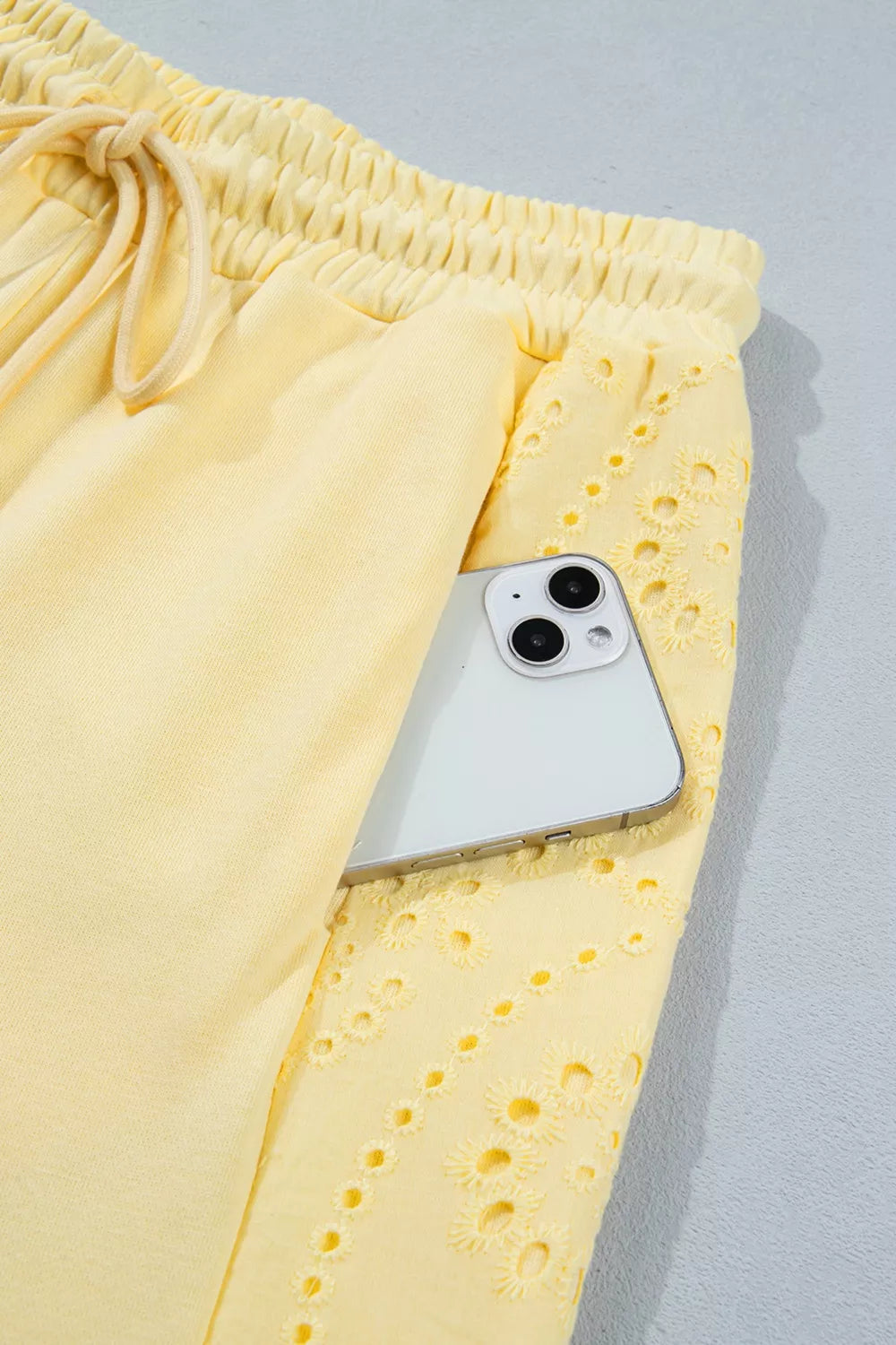 Plush Fashion Hub rings set featuring a half sleeve top and drawstring pants with decorative rings detail.