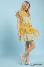 Umgee Mix Patchwork Flutter Sleeve Tiered Dress, stylish boho dress with patchwork design and flutter sleeves on a model.