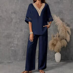 Women's embroidered V-neck top and wide-leg pants set by FitiqueFit in various colors, displayed on a model.