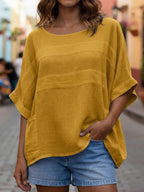 Loose-fitting plush fashion hub crew neck top with three-quarter-length sleeves, styled casually in neutral fabric.