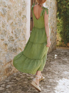 Women's cotton tiered frill V-neck sleeveless summer dress by Trendsi, featuring a flowy design and feminine ruffle details.
