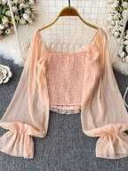 Women's elegant frill flounce sleeve smocked blouse made of lightweight polyester, stylish dress with feminine detailing.