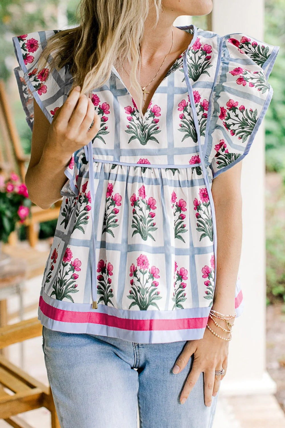 Women's floral print ruffle sleeve blouse with lightweight fabric and tied neckline, stylish top by Trendsi.
