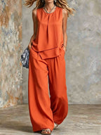 Women's sleeveless two-piece set with solid color wide-leg pants and matching top, stylish and comfortable from Plush Fashion Hub.