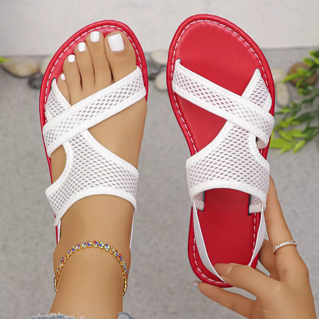 Shopimist crisscross mesh sandals with open toe design and adjustable ankle straps on a beige background.