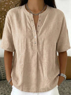 Light pink women's loose-fit short-sleeve pullover top by Plush Fashion Hub, casualwear, with a relaxed fit and solid color.