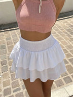 Smocked ruffled mini skirt from Trendsi showing a flowy, feminine design with ruffle details and smocked waistband.