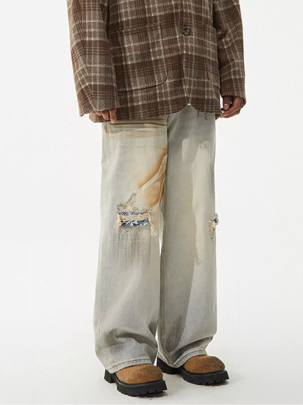 Men's distressed wide leg jeans by Trendsi, showing the rugged denim with frayed details and relaxed fit.