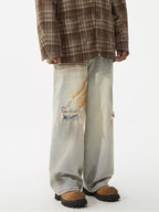 Men's distressed wide leg jeans by Trendsi, showing the rugged denim with frayed details and relaxed fit.