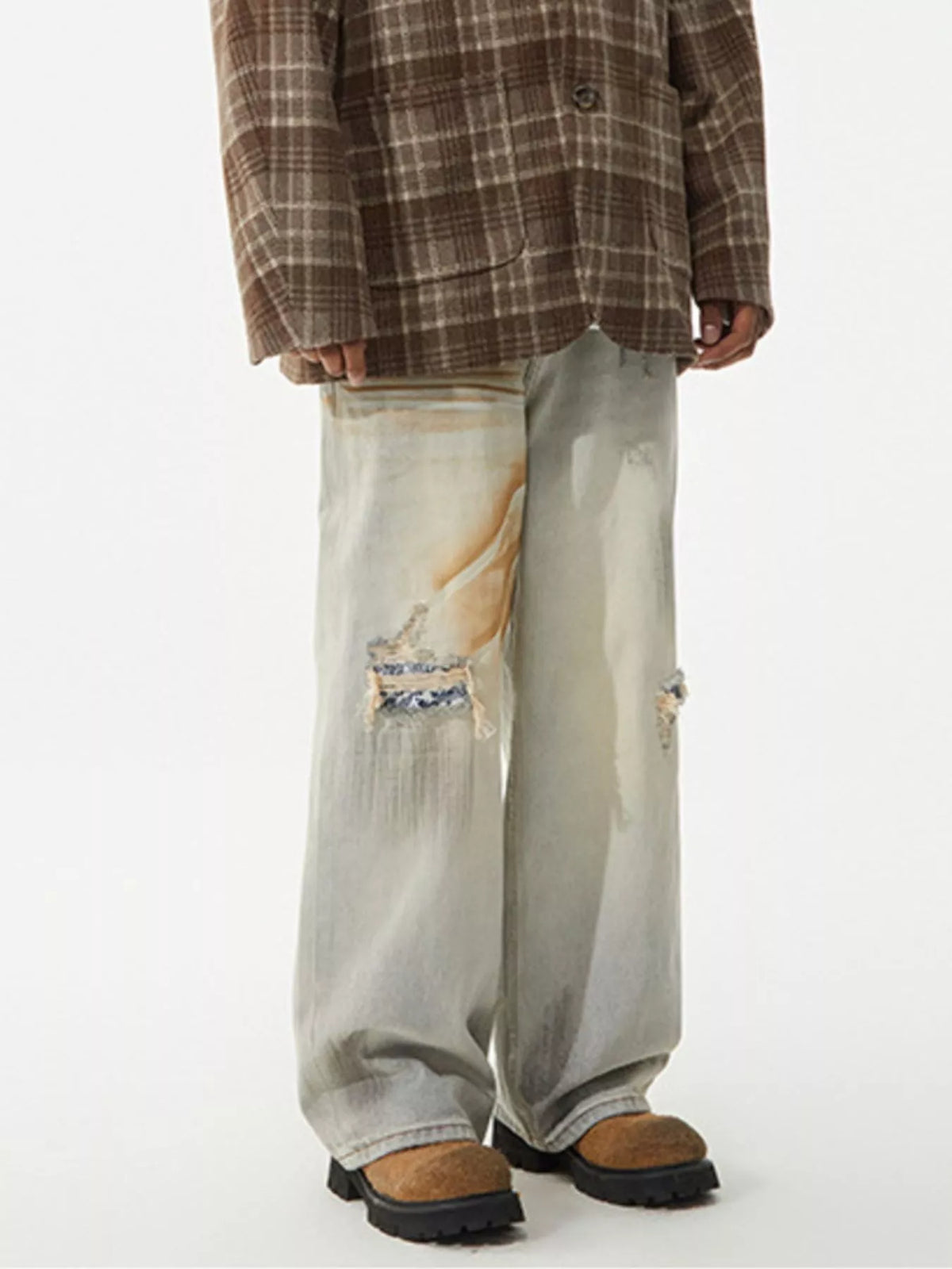 Men's distressed wide-leg jeans by Plush Fashion Hub, featuring faded denim with ripped details and a relaxed fit.