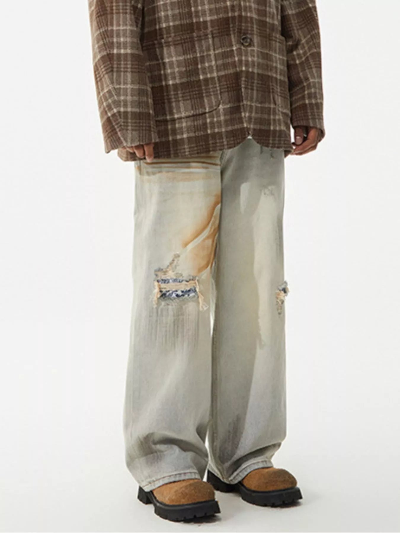 Men's distressed wide leg jeans by Trendsi, showing the rugged denim with frayed details and relaxed fit.