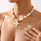 Pearl and cross pendant necklace from Shopimist featuring a delicate pearl drop and silver cross charm on a chain.