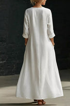 Trendsi surplice long sleeve maxi dress with a flowing silhouette and elegant neckline, displayed on a hanger against a neutral background.