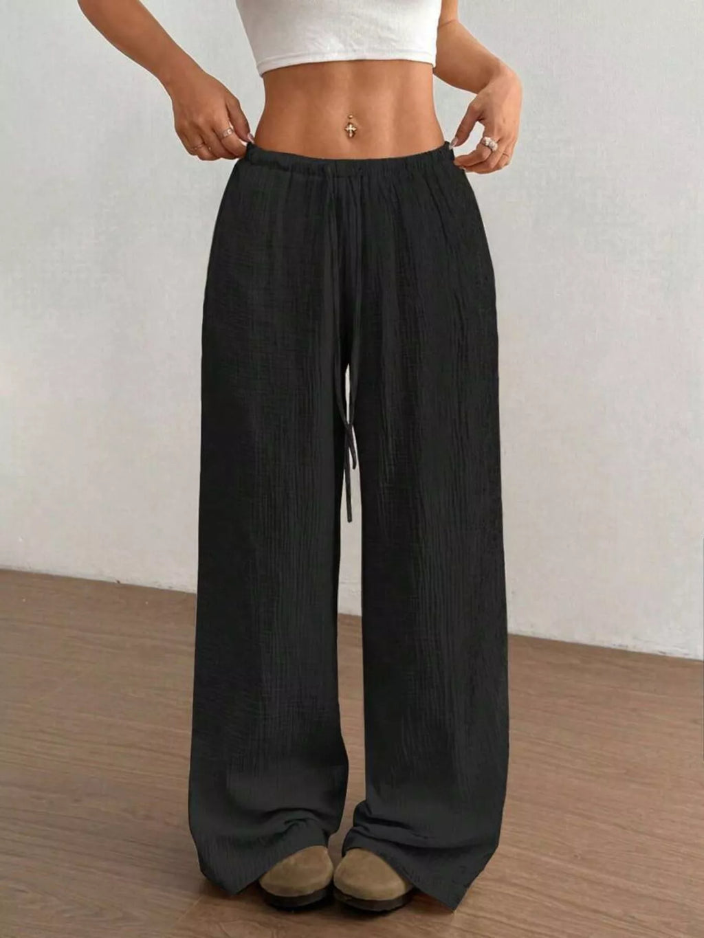 Wide-leg drawstring pants from Trendsi featuring a relaxed fit, high waist, and soft fabric in a neutral color.