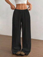 Wide-leg drawstring pants from Trendsi featuring a relaxed fit, high waist, and soft fabric in a neutral color.