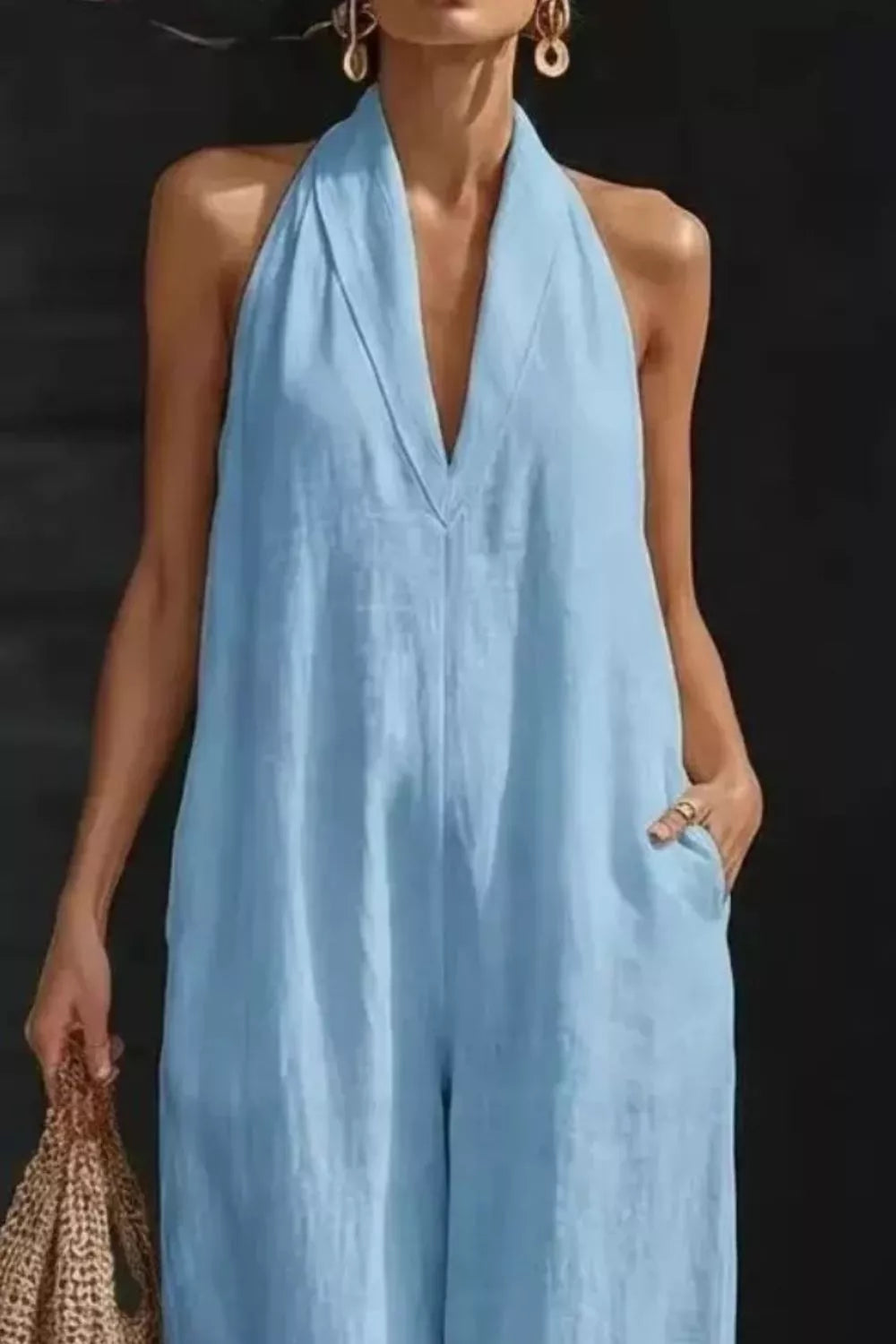 Women's sleeveless wide-leg jumpsuit with pockets, casual chic romper by Trendsi, shown in a relaxed fit with a stylish silhouette.