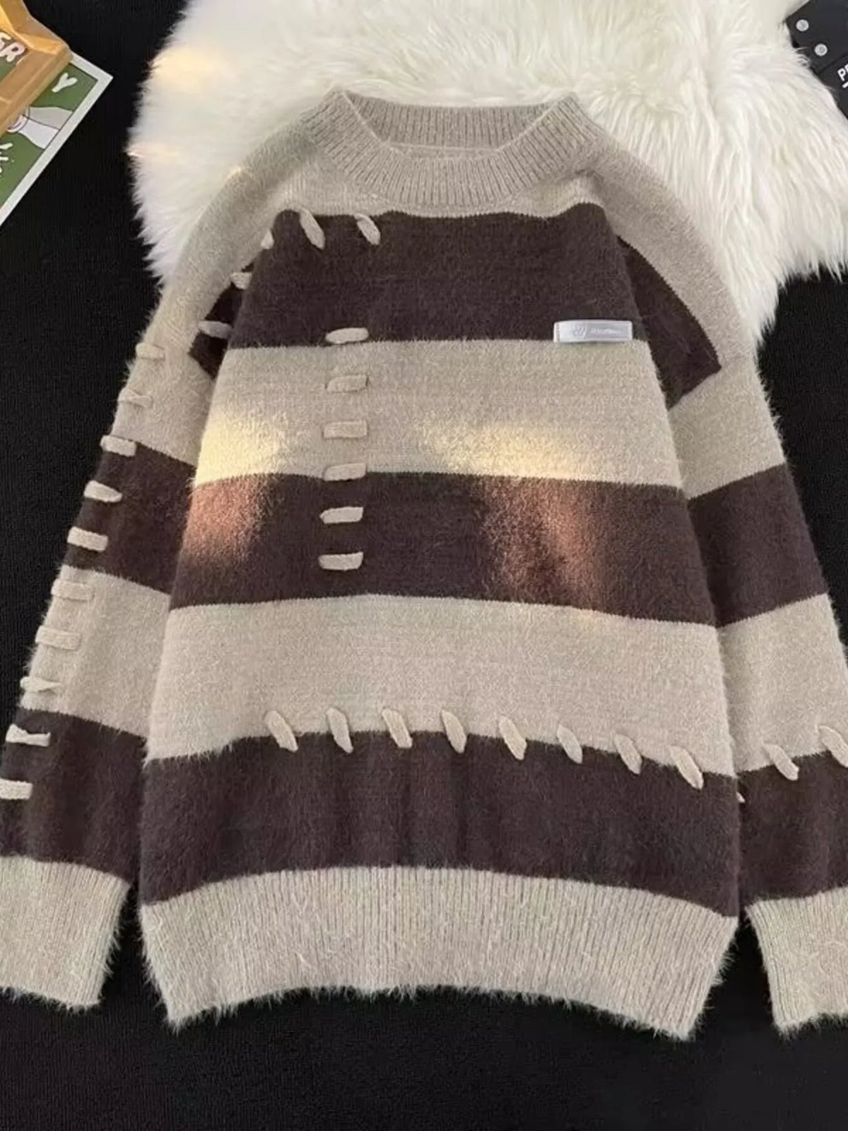 Men's striped knit pullover sweater with round neck from Trendsi, featuring a stylish multi-color striped pattern.