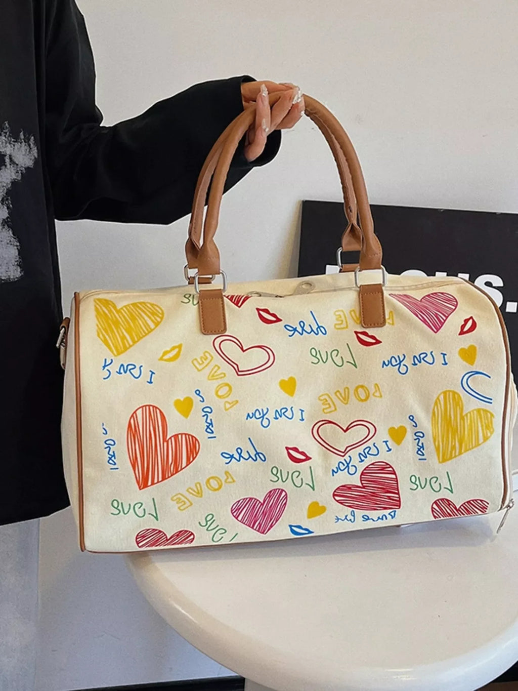 Printed duffel bag with adjustable strap by Shopimist, showing stylish design and sturdy handles for travel or gym use.