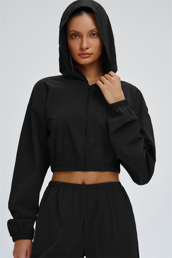 Svelte UV protection crop hoodie by Fitglutes Activewear, featuring a fitted design with UV shielding fabric for active workouts.