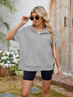 Black half zip short sleeve hooded top from Trendsi with a relaxed fit and lightweight fabric, perfect for casual wear.