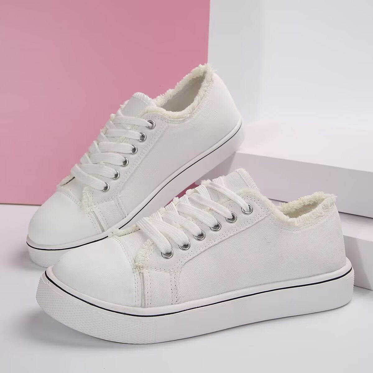 Women's lightweight lace-up canvas sneakers with flat soles and low-top design, featuring white and pastel color accents.