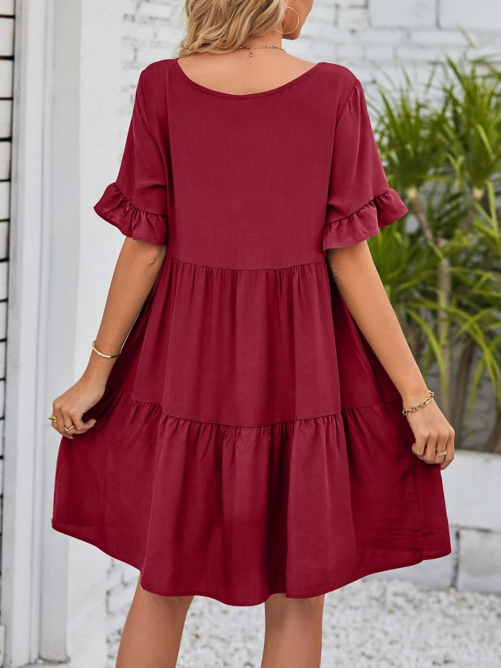 Lightweight rayon ruffled sleeve tiered mini dress with pockets, trendy and feminine, featuring a playful layered design.