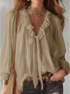 Shopimist ruffle long sleeve blouse with feminine design and soft fabric, featuring ruffled details on the sleeves and neckline.
