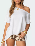 Women's off-shoulder asymmetrical flowy T-shirt by Trendsi, featuring a relaxed fit and stylish design, shown on a model.