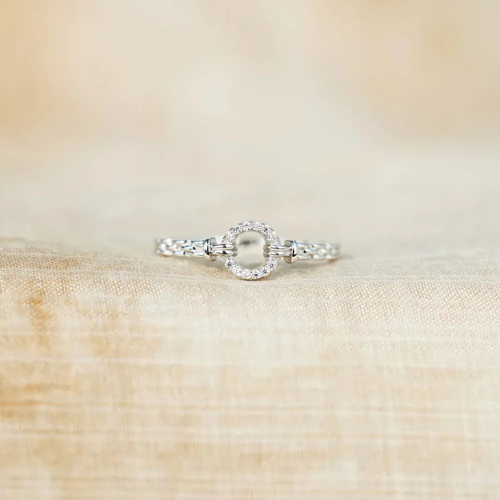 925 sterling silver ring with inlaid zircon stones, showcasing a sleek, polished design and sparkling details.